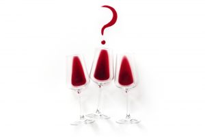 More Wine or Enough. Question mark over a wine glass on a white background